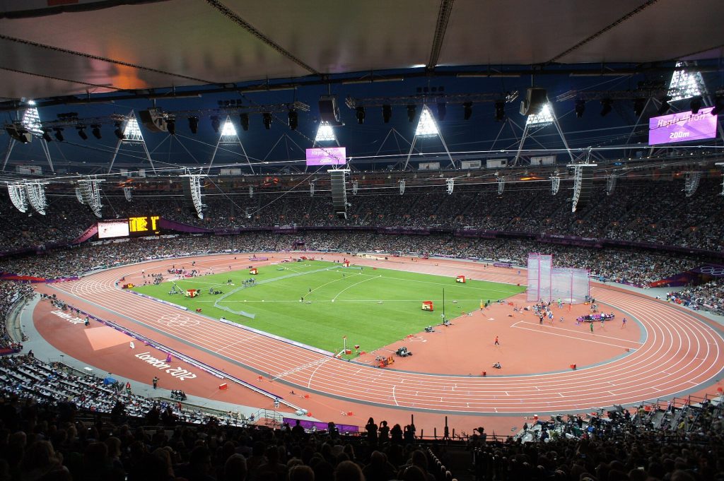 Football stadium under bright floodlights at night